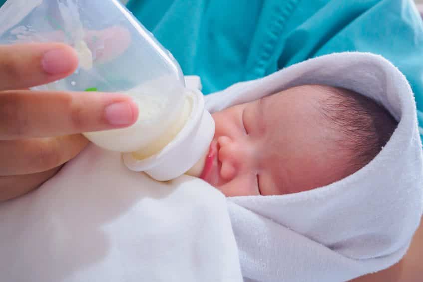 feeding a baby breastmilk out of a bottle