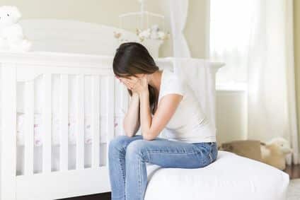 Fotolia_163917588_XS.jpg Depressed young woman in baby room